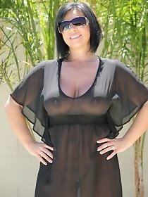 Brunette mature woman in black summer dress